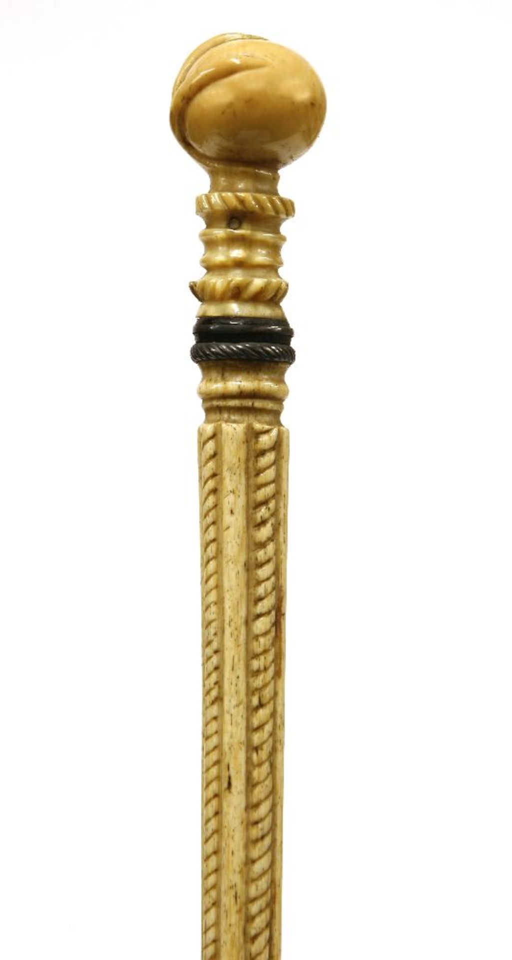 A marine ivory and whalebone walking stick,with a bird claw gripping a ball, over two baleen