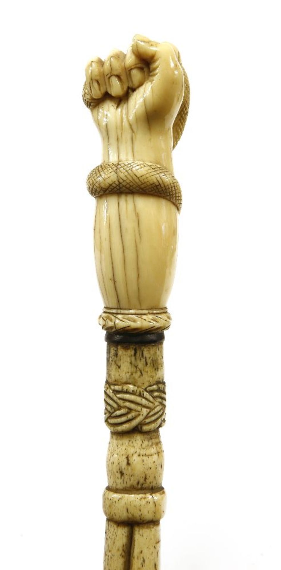 A marine ivory and whalebone walking stick,with a clenched hand gripping a serpent above a baleen