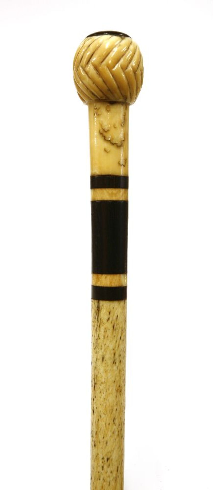 A marine ivory and whalebone walking stick,with a handle as a chevron carved ball with tortoiseshell