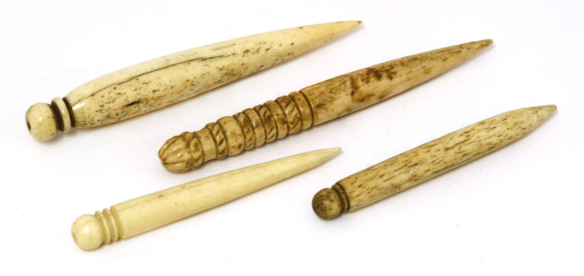 A group of four small marine ivory fids, one inscribed 'Charity' in copper pins,largest 9cm long (