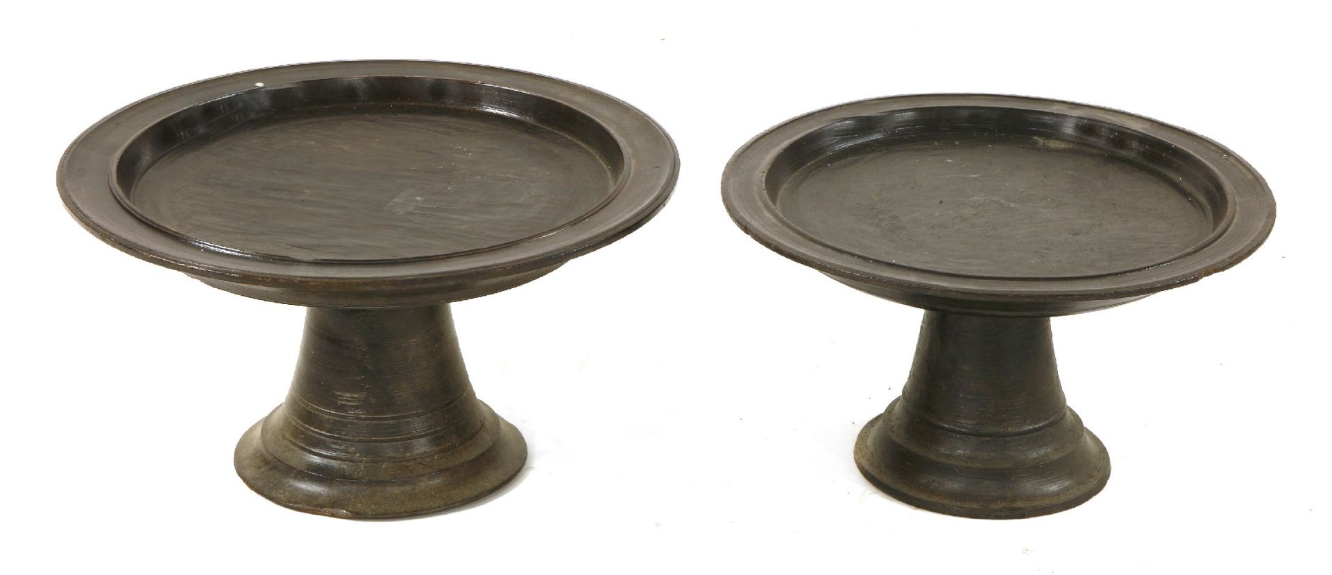 Two Javanese turned wood meal stands, early 20th century,48cm diameter27 and 30cm high (2)