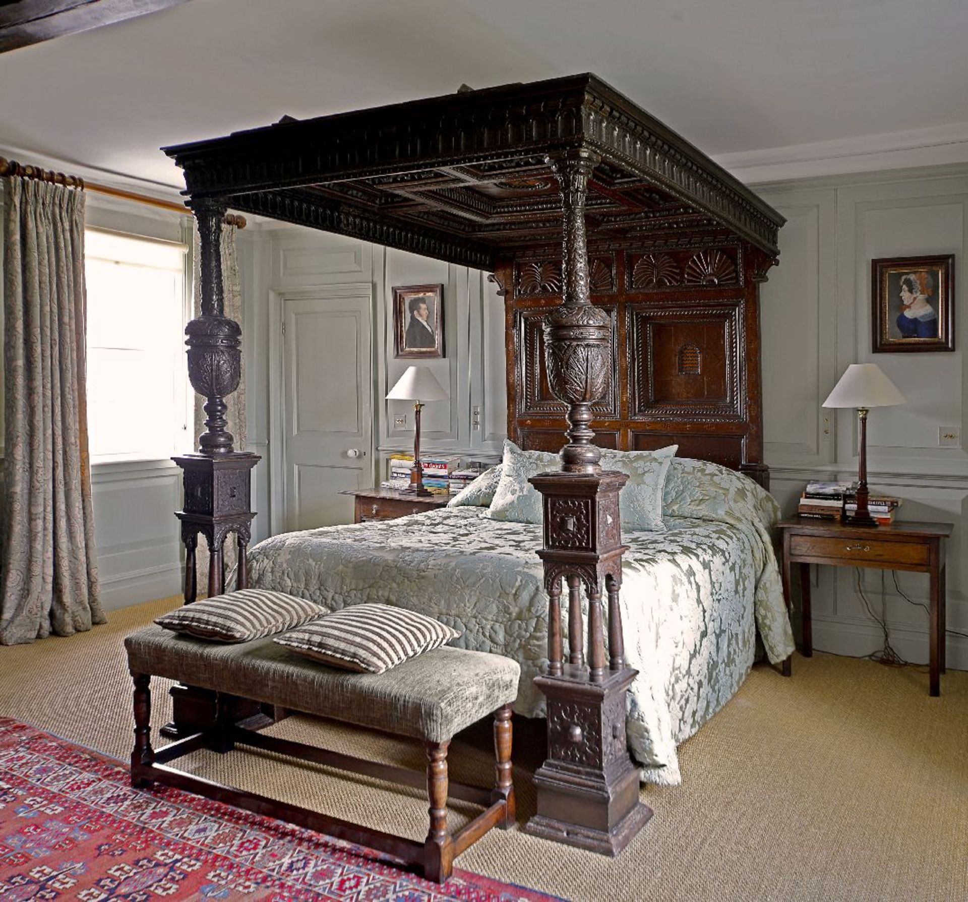 An impressive inlaid and carved oak tester bed,17th century and later, the panelled canopy with