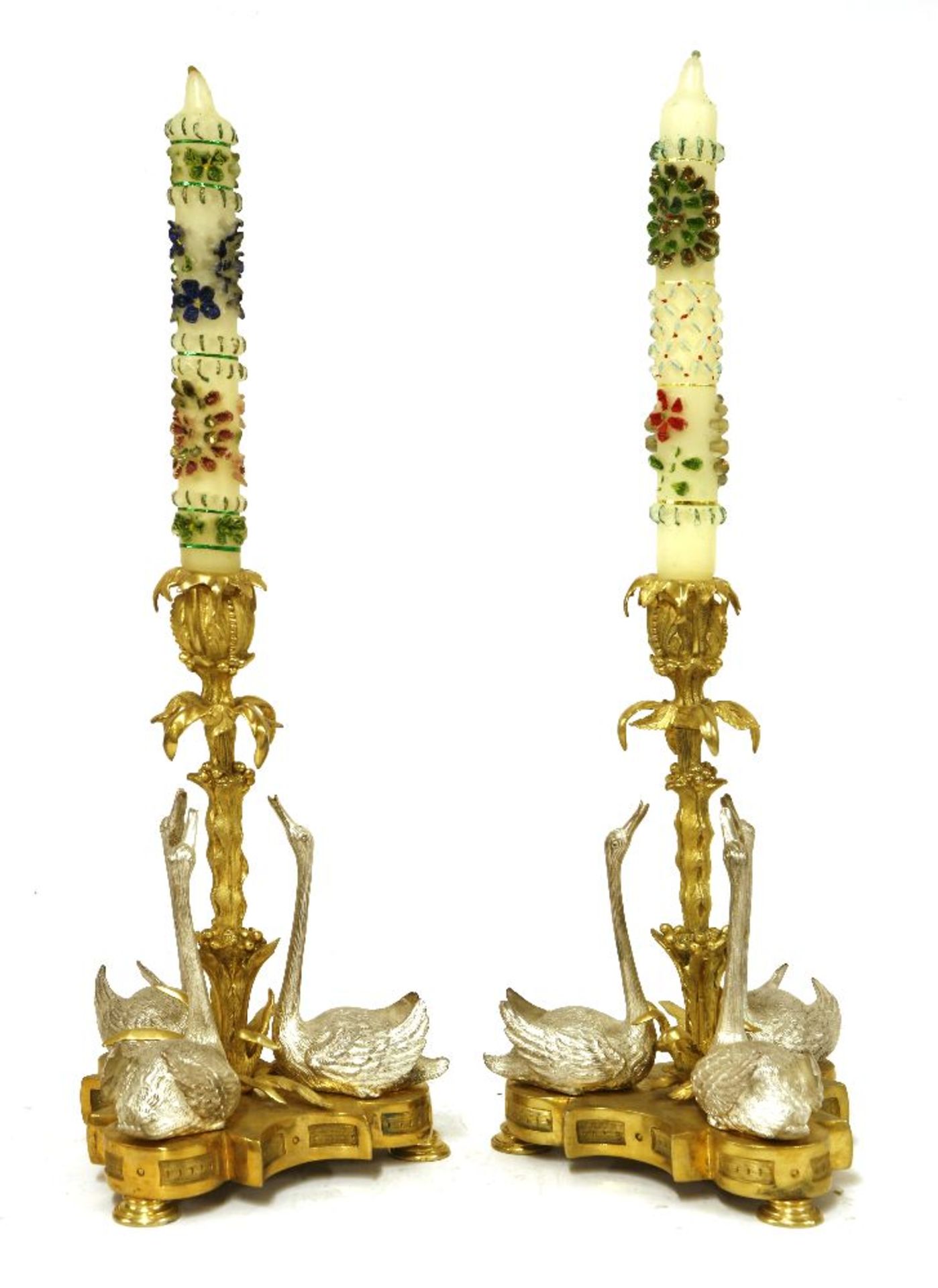 A pair of George IV gilt bronze and silvered candlesticks,each with a leaf-wrapped stem and