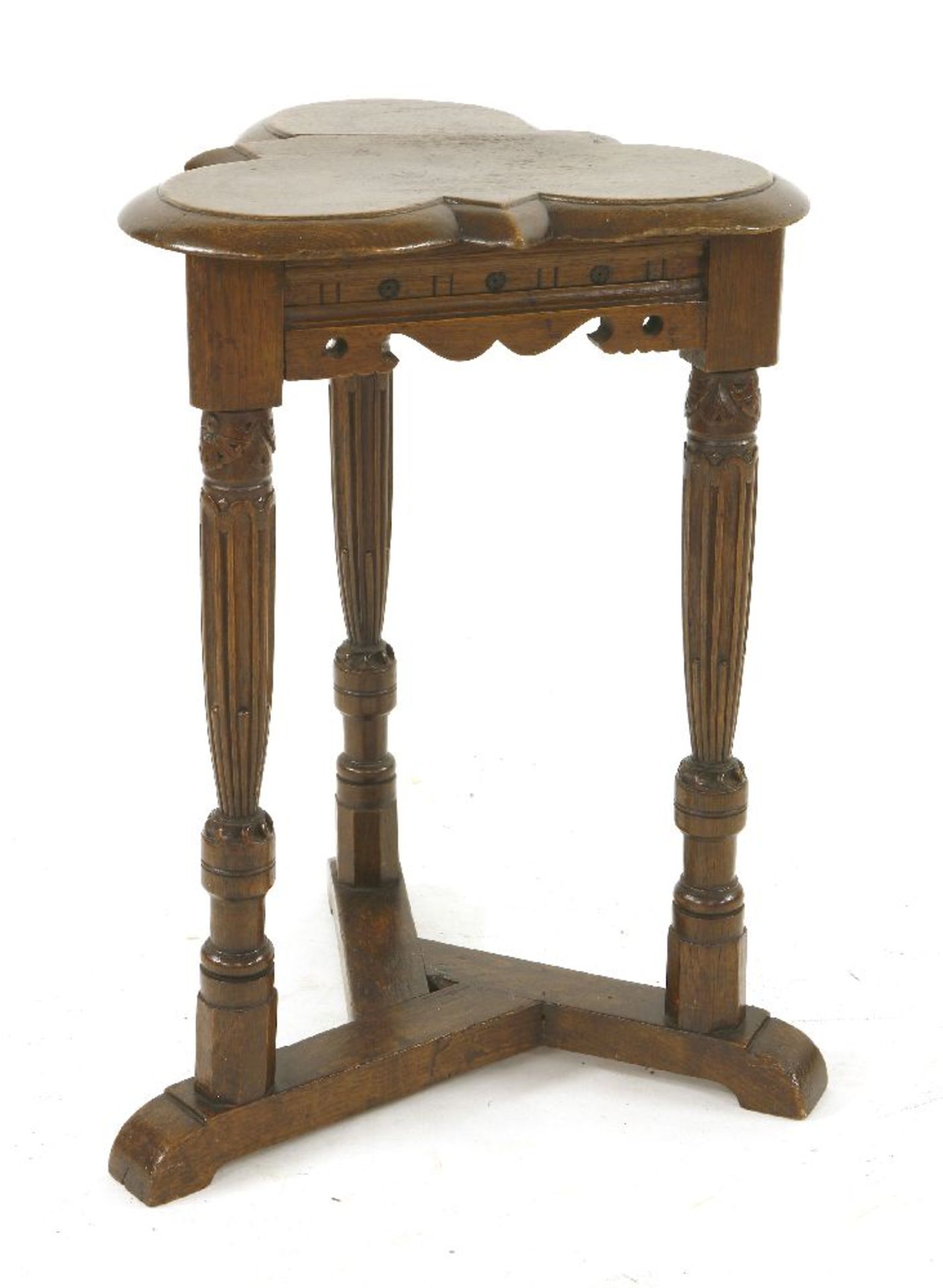 An oak trefoil table,17th century style, the moulded top on turned, stop fluted and carved