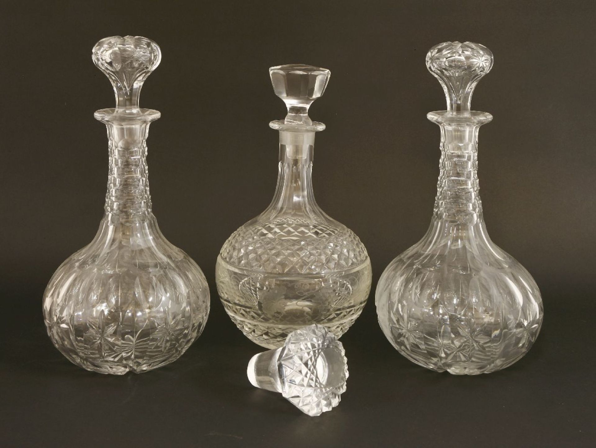 A pair of Victorian onion-shaped decanters and stoppers,with facet cut necks and bodies, each with