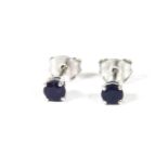 A pair of white gold single stone sapphire stud earrings, with post and butterfly fittings, marked