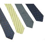Four Hermès silk ties, to include a yellow ground tie with a printed grey stirrup design, a blue