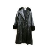 A ladies Loewe black leather coat, with black lambs fur to the collar and cuff, with monogrammed