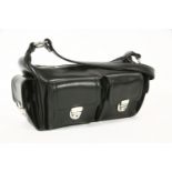 A Russell and Bromley black leather camera-style handbag, four exterior pockets with silver-tone