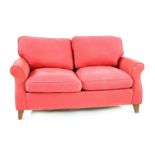 A contemporary red upholstered two seater settee, 154cm wide, 82cm deep, 87cm high