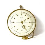 An Art Deco Kienzle brass cased wall clock and bracket, the circular dial with stylised hands,