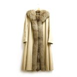A ladies mink lined mackintosh coat, a cream twill fabric, with a fox fur collar and edging to the