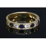 A gold sapphire and diamond half eternity ring, with alternating brilliant cut diamonds and circular