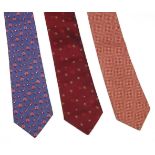 Three Hermès silk ties, to include a blue silk ground tie with a printed pink peacock design, a
