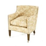 An Edwardian upholstered tub chair, the modern upholstery, and cushion on square tapering oak