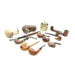 A collection of Meerscham pipes, silver mounted, along with other pipes, cheroot holders, and a