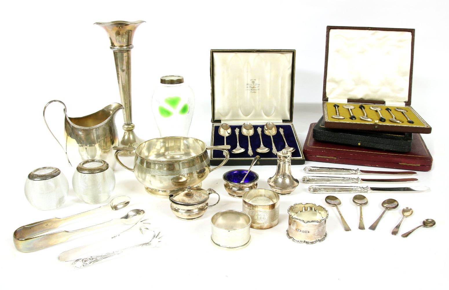A collection of silver items, to include silver rimmed match strikers, silver napkin rings, cased