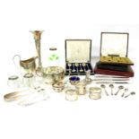 A collection of silver items, to include silver rimmed match strikers, silver napkin rings, cased
