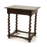 An oak side table,18th century and later, the rectangular top on twist turned supports and a flat