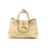 A Dolce and Gabbana beige leather handbag, featuring a pebbled beige exterior, with gold-tone