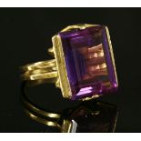 A Continental gold single stone synthetic sapphire ring, c.1970,with a rectangular step cut purple