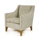A modern tub chair, with pale green upholstery, on square tapering beechwood front legsProvenance: