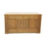 A carved oak coffer, the front panel with scrolling and foliate designs, 131cm wide, 59cm deep,