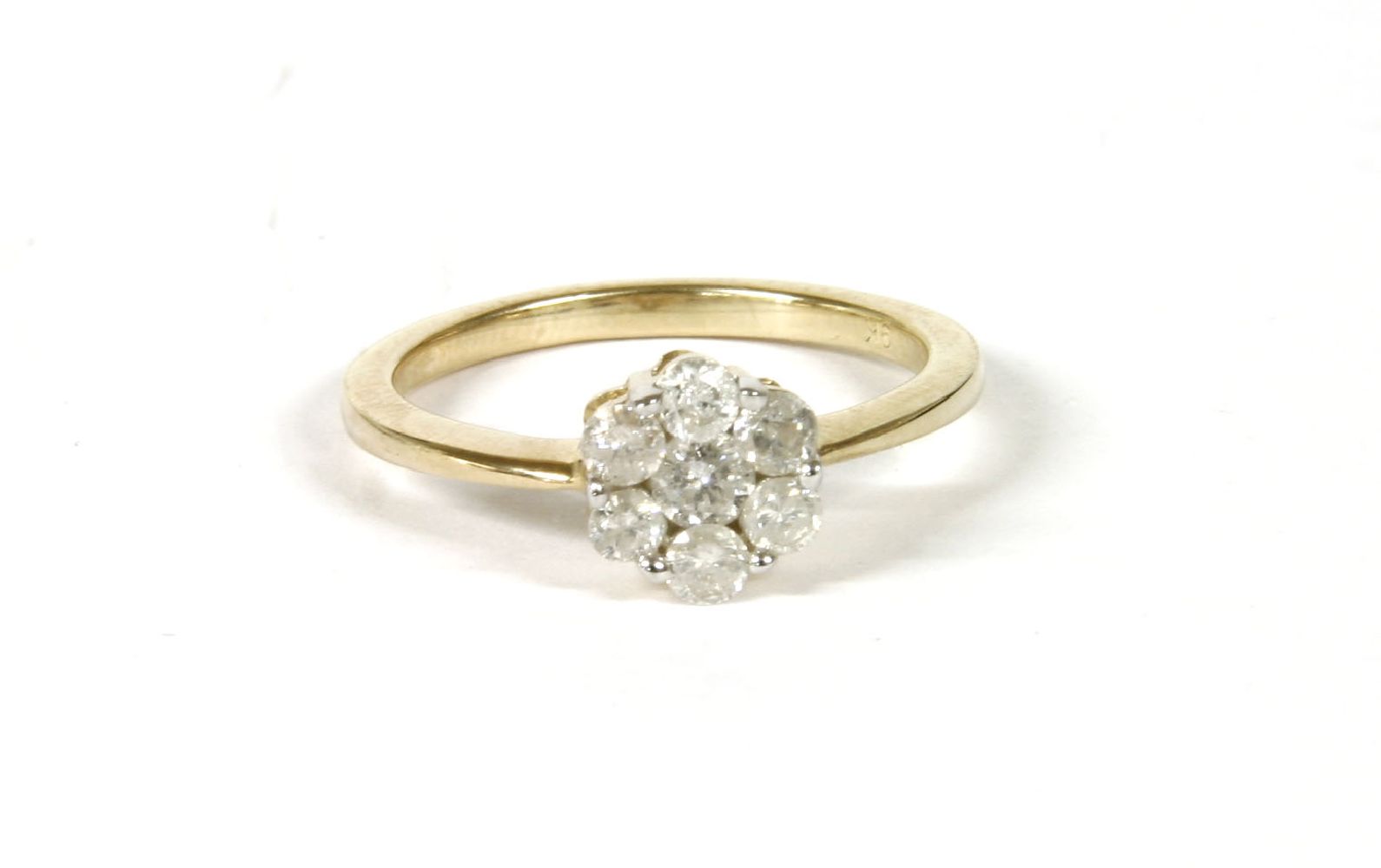 A gold diamond Daisy cluster ring, claw set to tapering shoulders and a plain polished shank, marked