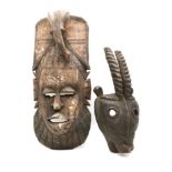 A North African carved tribal mask, 55cm high, and one other with horn detail, 42cm high (2)