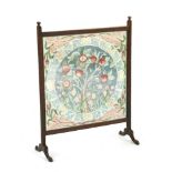 An oak and embroidered firescreen,labelled `Beatrice, 1938', 63cm wide, 82cm high