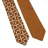 Two Hermès silk ties in boxes, to include an orange silk ground with a printed cream and grey