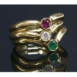 A three row gem set half wishbone gold hinged ring, with a circular mixed cut ruby, a brilliant