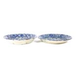 A pair of blue and white pottery plates, 19th century, Continental, each with heraldic devices,