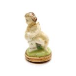 A porcelain seal fob in the shape of a cherub, mid to late 18th century, probably Chelsea porcelain,
