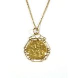 A 1915 half sovereign, claw set to a 9ct gold scroll mount, on a gold chain, tested as approximately