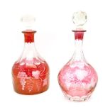 Two ruby flashed decanters, the bodies with wheel cut grape and vine decoration