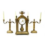 A late 19th century French brass clock garniture. 47cm high