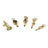 Five assorted watch keys, to include a gold trumpet shaped example with foiled quartz finial, a