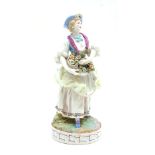 A 19th century Meissen figure of a flower lady, blue crossed swords mark the base, 27cm high