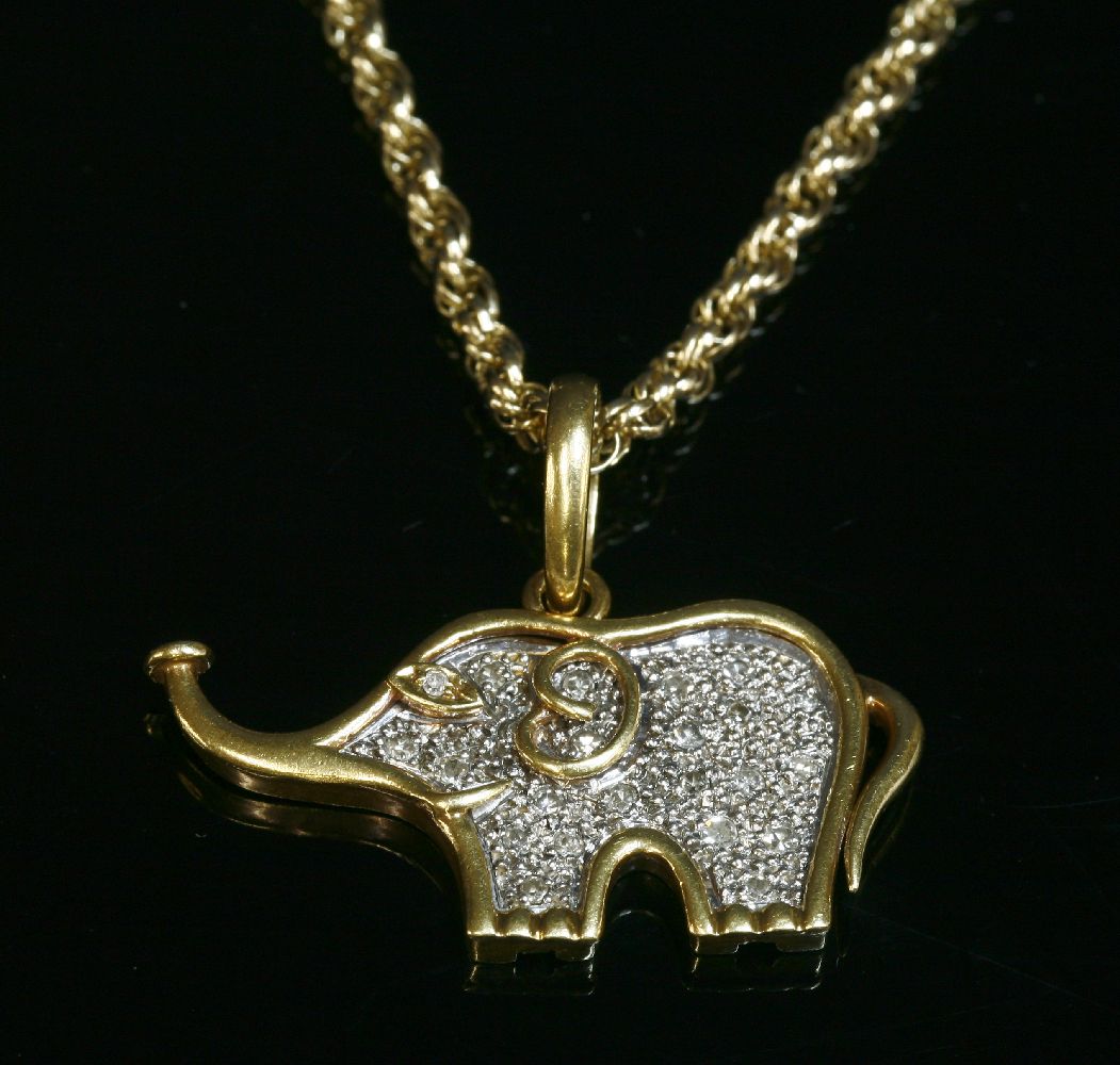 A two colour gold, diamond set, elephant pendant, with a flat section white gold centre, pavé set