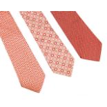 Three Loewe silk ties, comprising three pink examples, one with a floral design, a spotted design,