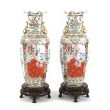 A pair of large Chinese famille rose vases, painted with flowers and figures, gilt handles, 93cm
