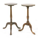 Two mahogany tripod lamp tables,George III and later, each with a circular top and turned column,