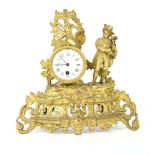 An early 20th Century gilt spelter mantle clock, with pierced panels showing musical motifs and