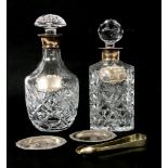 A cut crystal glass whisky decanter, with silver collar and spirit label