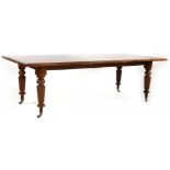 A mahogany dining table,the modern top with a moulded edge on four Victorian turned and reeded legs,