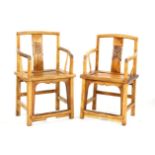 A pair of Chinese design pale hardwood open armchairs, with hooped backs above solid seats on