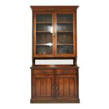 A Victorian walnut bookcase with two glazed upper doors.122cm wide, 40cm deep, 243cm high.