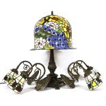 A Tiffany design table lamp with faux stamped glass shade on naturalistic base, 61cm high,