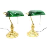 A pair of brass bankers' lamps, with green glass shades